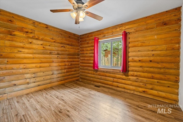 9 Elderberry Cir, Idaho City, ID 83631 - unfurnished room with ceiling fan, wood finished floors, and log walls