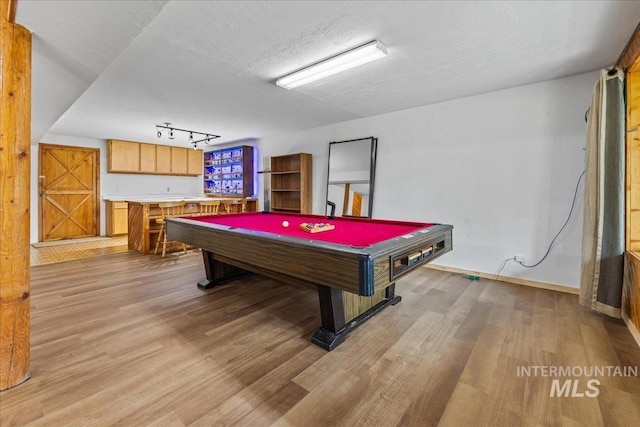 9 Elderberry Cir, Idaho City, ID 83631 - recreation room with light wood-style flooring, billiards, a textured ceiling, baseboards, and rail lighting