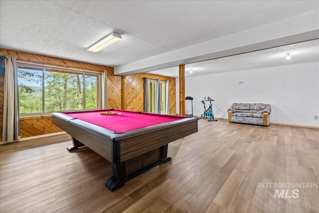 9 Elderberry Cir, Idaho City, ID 83631 - playroom with billiards, wood finished floors, wooden walls, a textured ceiling, and baseboards