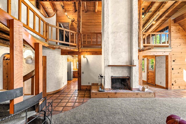 kitchen with stainless steel dishwasher, wood-type flooring, kitchen peninsula, beam ceiling, and white electric range oven