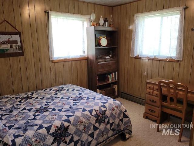 607/611 S Main St, Cascade, ID 83611 - bedroom featuring wooden walls, a baseboard heating unit, and light colored carpet