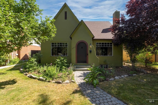 2410 W State St, Boise, ID 83702 - view of front facade with roof with shingles, a front yard, stucco siding, and a chimney