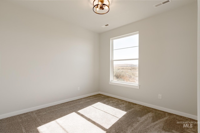 unfurnished room with baseboards, visible vents, and carpet flooring