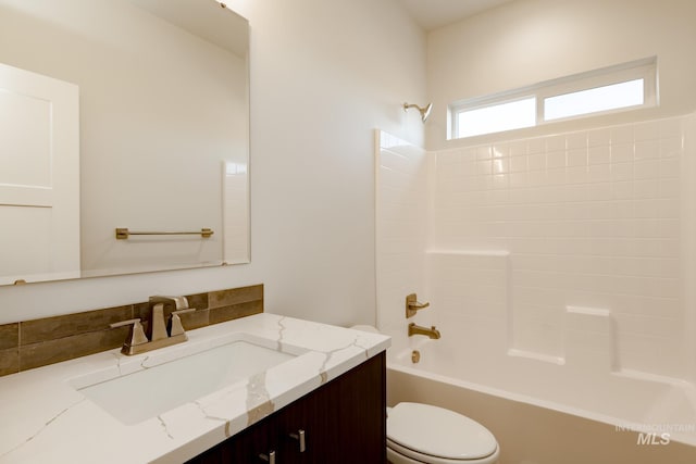 bathroom featuring shower / bath combination, vanity, and toilet