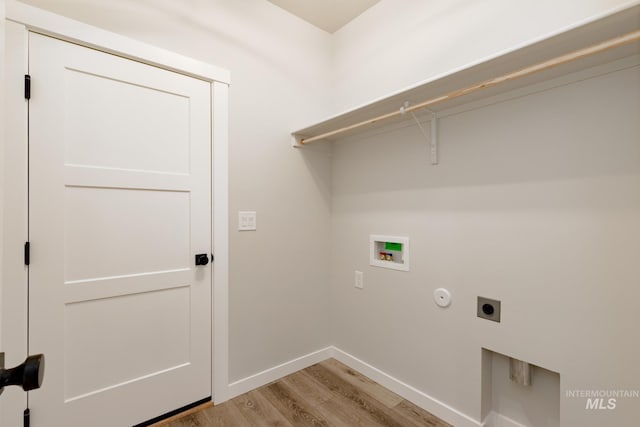 washroom with laundry area, baseboards, hookup for a washing machine, hookup for an electric dryer, and light wood-type flooring