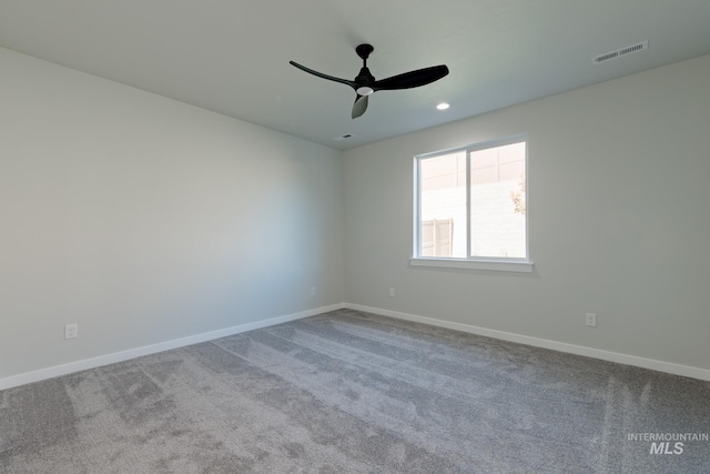 carpeted spare room featuring a ceiling fan, recessed lighting, visible vents, and baseboards