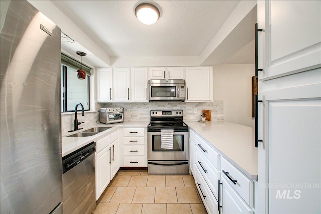 3017 S Windstream Ln, Boise, ID 83706 - kitchen featuring appliances with stainless steel finishes, a sink, backsplash, white cabinetry, and light countertops