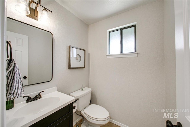 3017 S Windstream Ln, Boise, ID 83706 - half bath featuring vanity, toilet, baseboards, and a textured wall