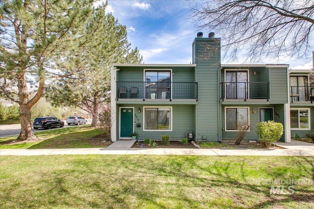 3017 S Windstream Ln, Boise, ID 83706 - view of front facade featuring a balcony, a chimney, and a front lawn