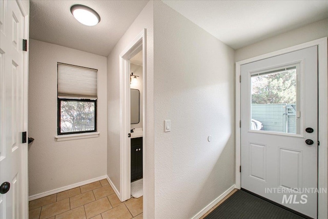 3017 S Windstream Ln, Boise, ID 83706 - doorway to outside featuring baseboards and light tile patterned flooring