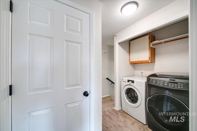 3017 S Windstream Ln, Boise, ID 83706 - laundry area with cabinet space, washing machine and dryer, light colored carpet, baseboards, and a textured ceiling