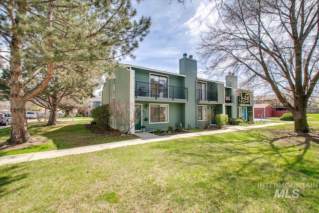 3017 S Windstream Ln, Boise, ID 83706 - view of property with a balcony, a chimney, and a front yard