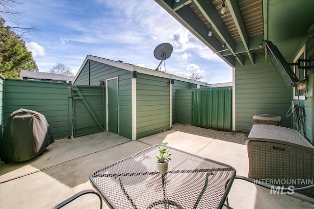 3017 S Windstream Ln, Boise, ID 83706 - view of patio featuring a fenced backyard, a shed, an outdoor structure, and central AC