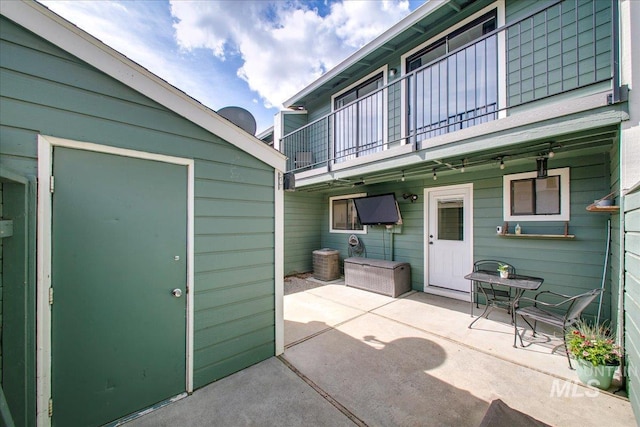 3017 S Windstream Ln, Boise, ID 83706 - view of patio with a balcony, an outbuilding, and a storage shed