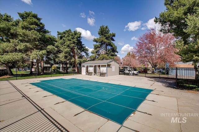 3017 S Windstream Ln, Boise, ID 83706 - view of swimming pool with a patio, fence, an outbuilding, and a storage structure