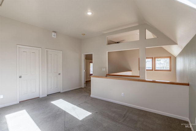 interior space with baseboards, plenty of natural light, and lofted ceiling