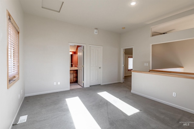 unfurnished bedroom with carpet floors, baseboards, ensuite bathroom, and recessed lighting