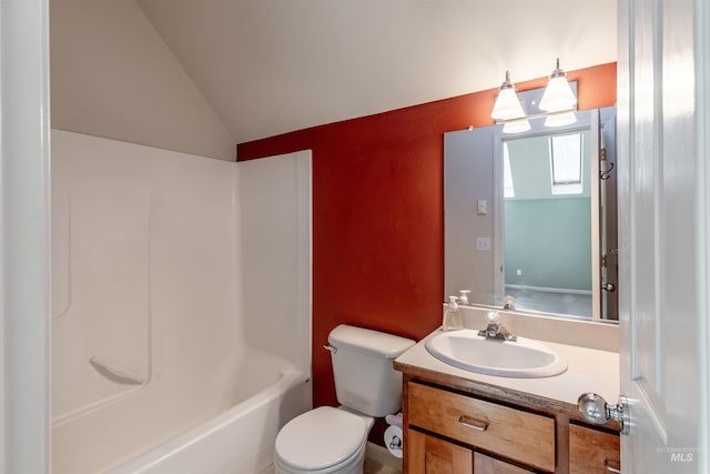 bathroom with toilet, vaulted ceiling, and vanity