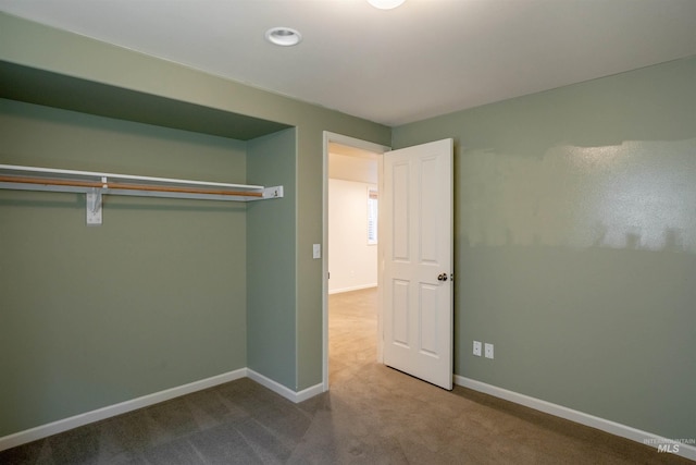 unfurnished bedroom featuring baseboards and carpet flooring