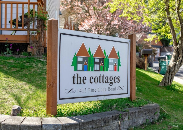 community / neighborhood sign with a yard