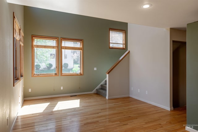spare room with visible vents, baseboards, stairway, recessed lighting, and light wood finished floors