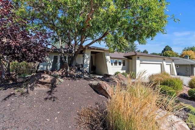 single story home with a garage and stucco siding