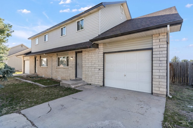 view of front of house featuring concrete driveway, a shingled roof, an attached garage, and fence