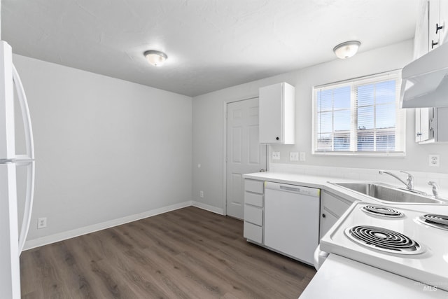 kitchen featuring white appliances, under cabinet range hood, white cabinets, and a sink