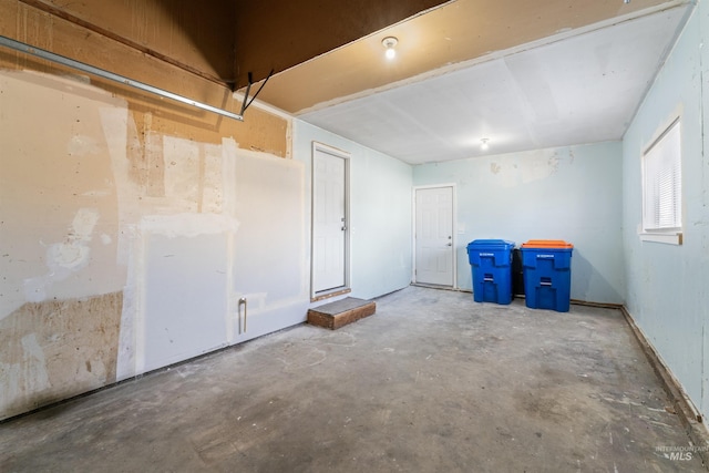 spare room with unfinished concrete flooring