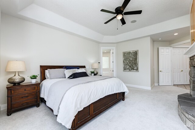 3586 N Croft Way, Eagle, ID 83616 - bedroom featuring light colored carpet, a tray ceiling, baseboards, and a ceiling fan