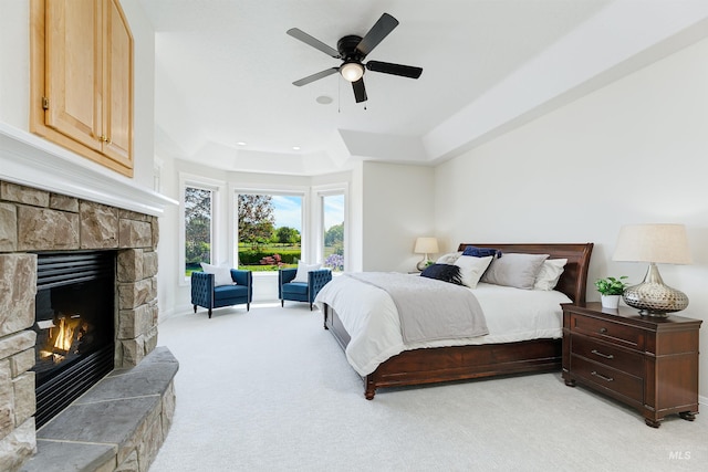 3586 N Croft Way, Eagle, ID 83616 - bedroom featuring a raised ceiling, light colored carpet, a stone fireplace, a ceiling fan, and recessed lighting