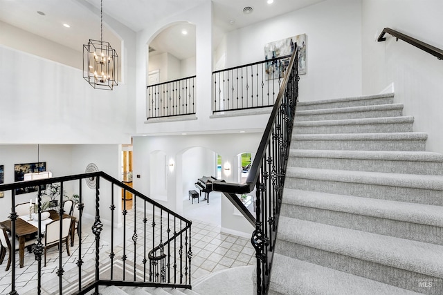 3586 N Croft Way, Eagle, ID 83616 - stairway featuring arched walkways, a chandelier, recessed lighting, baseboards, and a high ceiling