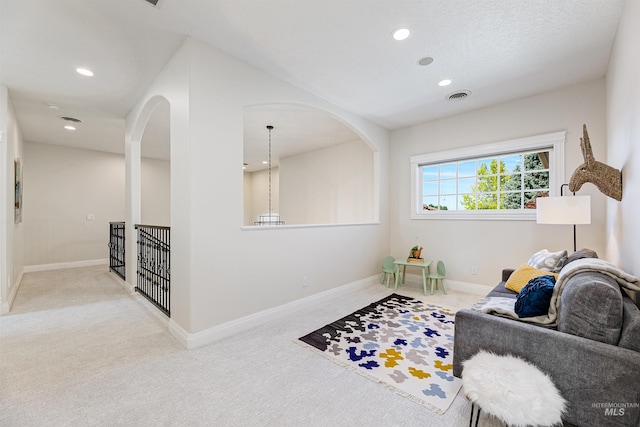 3586 N Croft Way, Eagle, ID 83616 - carpeted living room featuring recessed lighting, arched walkways, and baseboards