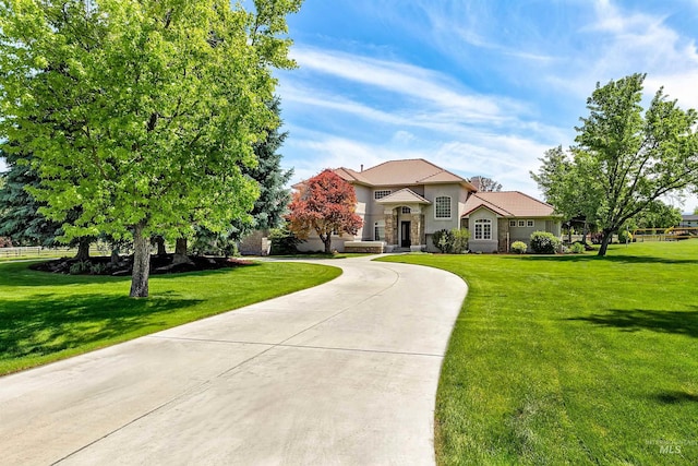 3586 N Croft Way, Eagle, ID 83616 - view of front of property with stucco siding, a front lawn, curved driveway, and stone siding