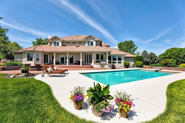 3586 N Croft Way, Eagle, ID 83616 - back of property featuring a patio, an outdoor pool, a lawn, stucco siding, and a tile roof