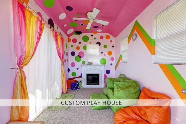 3586 N Croft Way, Eagle, ID 83616 - playroom with carpet flooring, lofted ceiling, a ceiling fan, and a glass covered fireplace