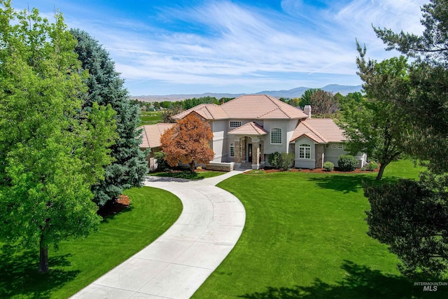 3586 N Croft Way, Eagle, ID 83616 - view of front of home featuring a tile roof, stucco siding, a mountain view, a front lawn, and concrete driveway