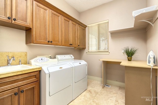 laundry room featuring washing machine and clothes dryer, cabinet space, and baseboards