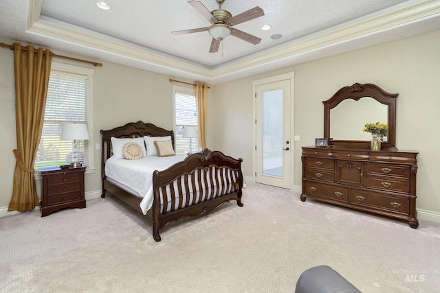 bedroom featuring a raised ceiling, light carpet, access to outside, baseboards, and ceiling fan