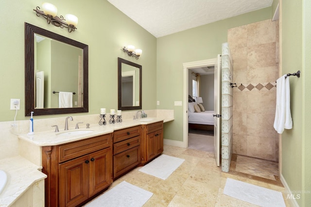 ensuite bathroom with double vanity, a walk in shower, a tub to relax in, baseboards, and tile patterned floors