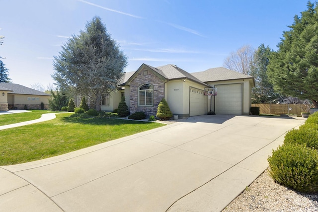 view of front of home featuring an attached garage, concrete driveway, stucco siding, and stone siding