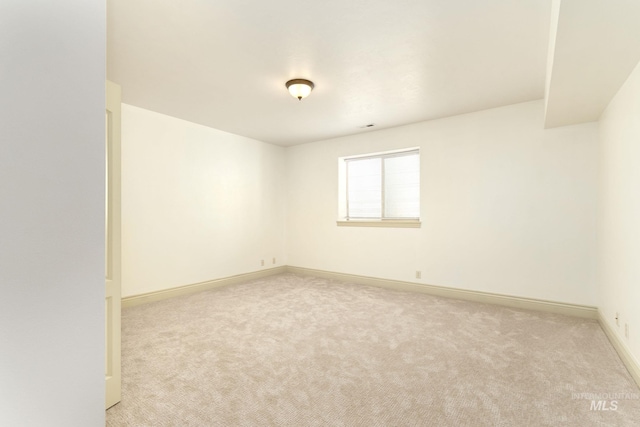 empty room with carpet flooring and baseboards