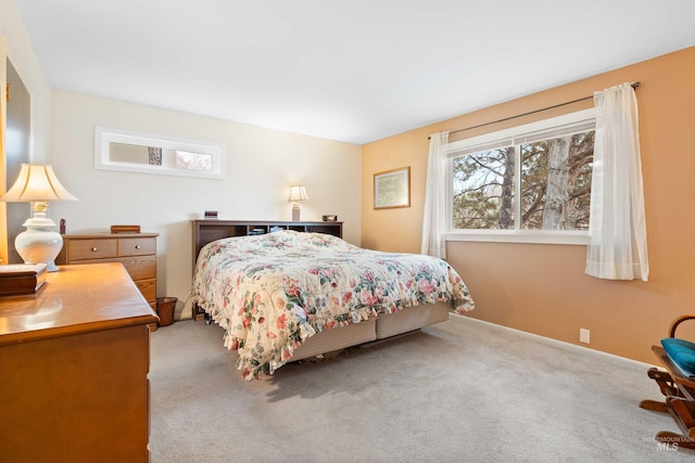 bedroom featuring baseboards and carpet flooring