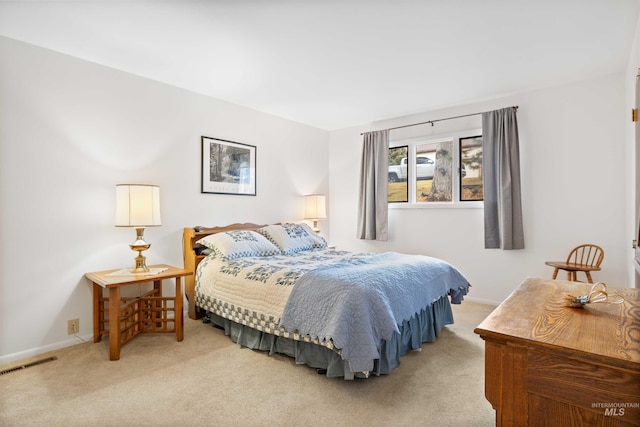 carpeted bedroom with baseboards and visible vents