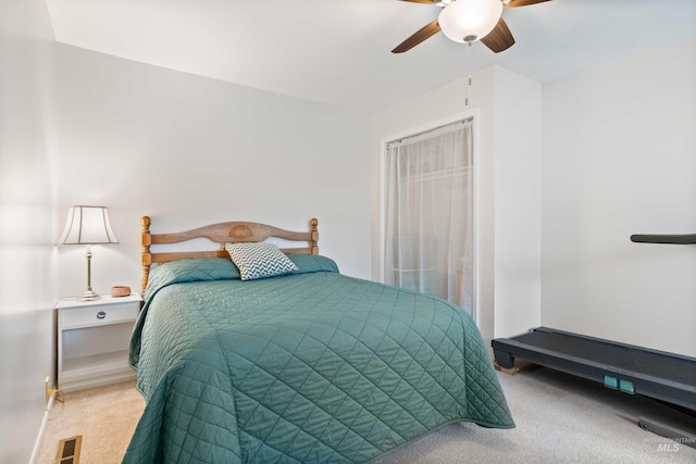 carpeted bedroom featuring ceiling fan and visible vents