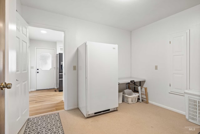 interior space with light colored carpet and baseboards