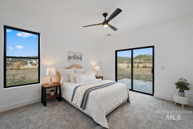 carpeted bedroom with baseboards, ceiling fan, visible vents, and access to exterior