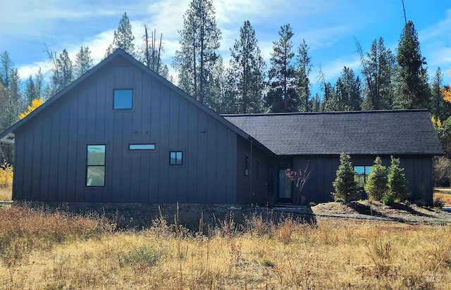 view of property exterior with roof with shingles