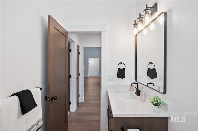 bathroom featuring wood finished floors and vanity