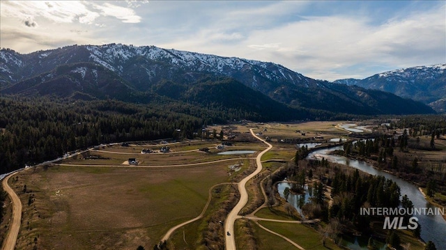 bird's eye view featuring a wooded view and a water and mountain view